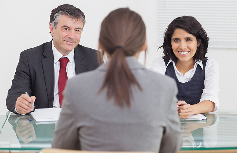 Business people talking and smiling in a small meeting